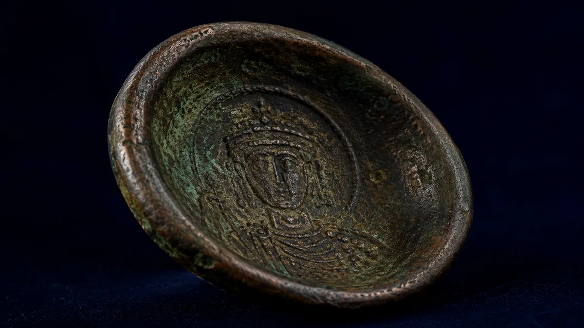 Cup-shaped scyphate bronze coin with heavy patina