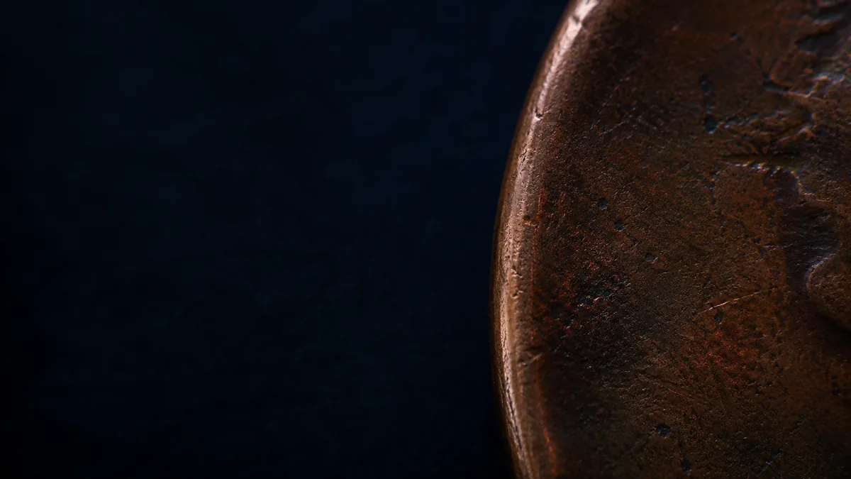 Macro photograph of an aged copper coin edge and rim